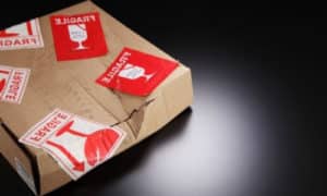 scatola contentente oggetti fragili accuratamente imballata e con etichetta scritto fragile